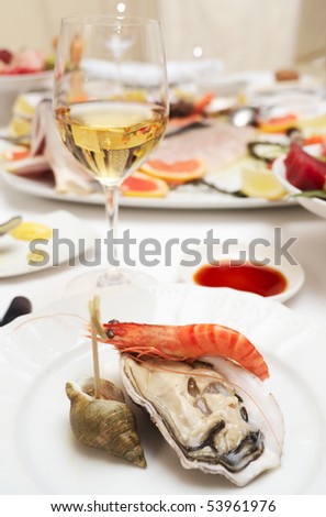 Oyster and prawn on plate in a restaurant
