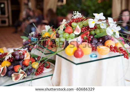 Fruits on banquet table, banquet, people in blurred background