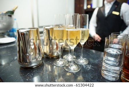 Bar counter with champagne, bartender in background
