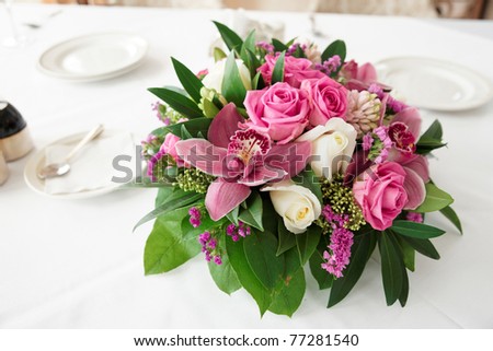 Bouquet of orchid flowers and tulips on arranged table