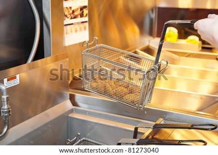 Deep fryer with boiling oil on restaurant kitchen