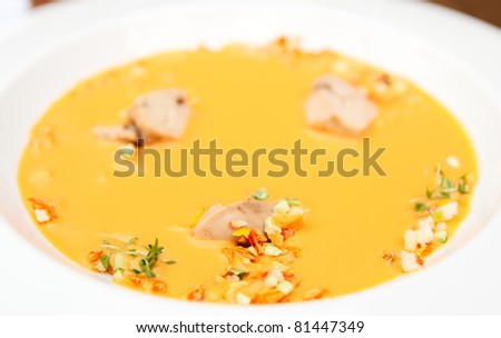 Gaspacho (cold summer soup) with cod liver in porcelain plate