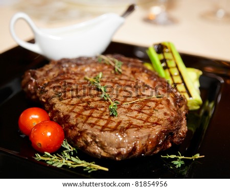 Rib eye steak served on black plate