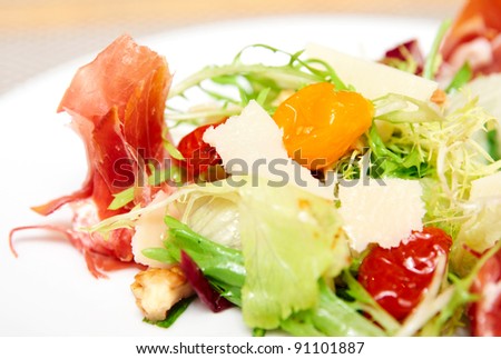 Salad with prosciutto ham ripened cheese, dried cherry tomatos and lettuce