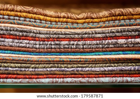 Cashmere shawls on shop shelf, close-up