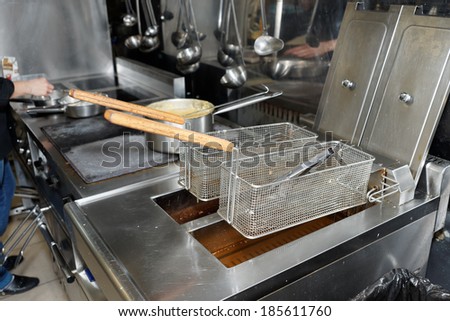 Deep fryers with boiling oil on fast food kitchen