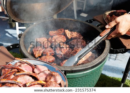 Venison being fried on grill at outdoor kitchen
