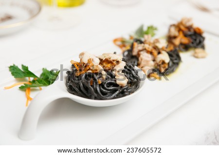 Black pasta with seafood, close-up