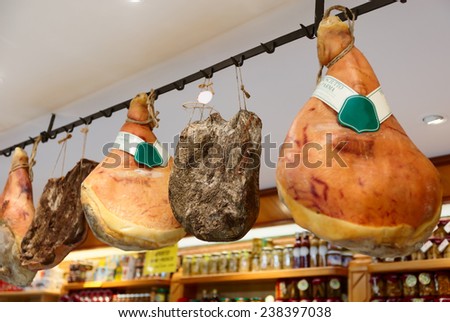 Prosciutto di parma hams in a shop, trademarks deleted