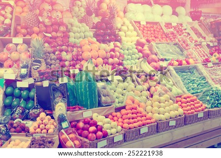 Shelf with fruits on a farm market, trademarks blurred or removed, toned image