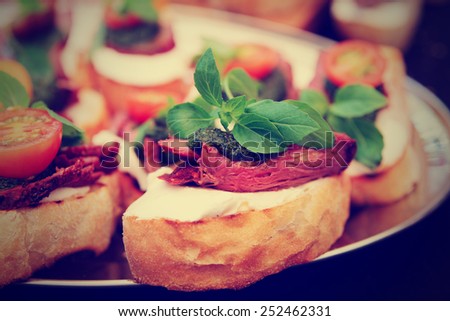 Bruschettas with beefsteak and pesto sauce, close-up, toned image