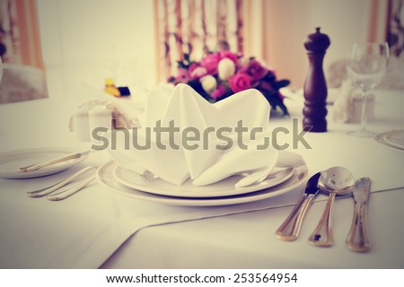 Place setting in an expensive haute cuisine restaurant, toned image