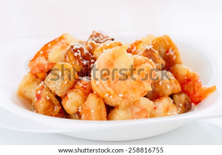 Deep fried eggplant and shrimps in sweet-sour sauce, close-up