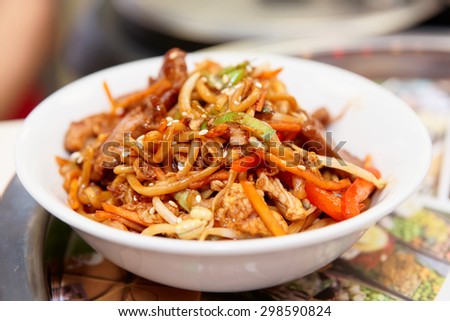 Noodles with soy sprouts and vegetables cooked in wok, typical asian food