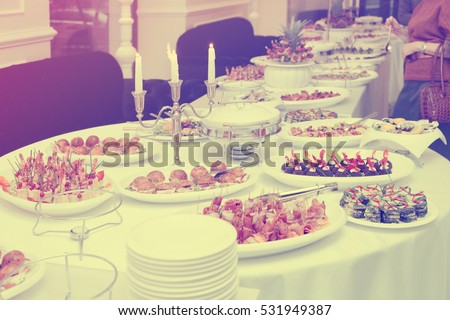 Meat and fish appetizers in a restaurant, toned image