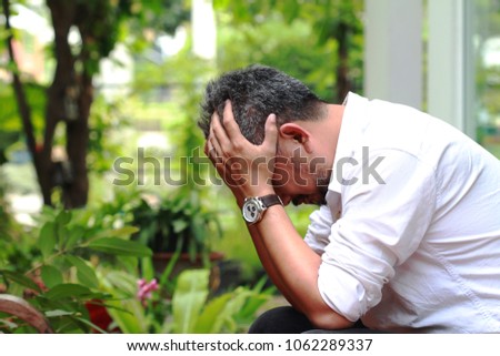 Image of elderly stressed man facepalm or cover his face by hands.4os or 50s man depressed,or may suffering from headaches and migraine as of Menopause in men,get trouble in his life
