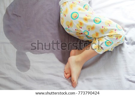 Image of child pee on the mattress.The picture of bed-wetting situation in 4 or 5 years old girl.Girl wet the bed while she was sleeping.Selective focus