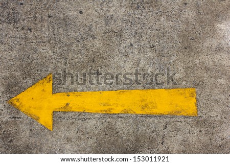 Yellow arrow left on asphalt street for the concept of choice