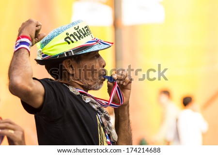 An unidentified old man blow a whistle in Anti-government protest at Democracy Monument on November 21, 2013 in Bangkok, Thailand. The protest Against The Amnesty bill in capital of Thailand