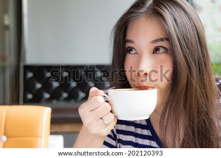 Beautiful asian woman woman drinking  cappuccino coffee