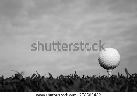 Black and white of golf ball on tee