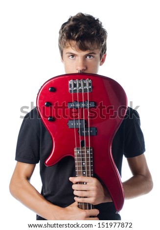 Teenager boy behind bass guitar, isolated on white