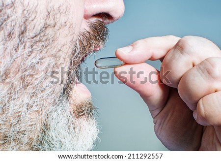Old man takes a pill