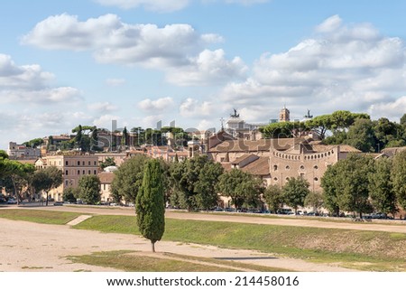 ROME - AUGUST 26: The Palatine hill facing the Circus Maximus under a blue sky. In the background the Alter of the Fatherland on August 26, 2014 in Rome.