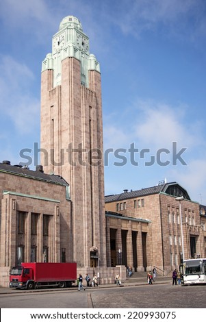 HELSINKI, FINLAND - MAY 15: The railway station watch tower, some people catch a bus on a sunny day on May 15, 2013 in Helsinki