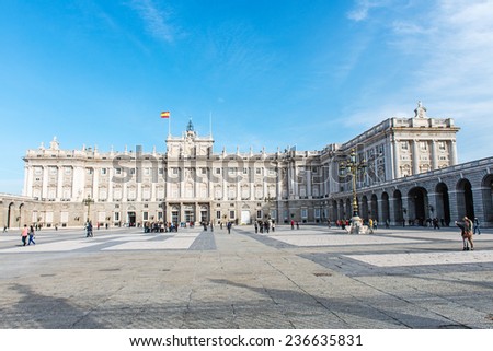 MADRID, NOVEMBER 22: Royal Palace of Madrid, close-up of the west facade (View from the Plaza de la Armeria) with some tourists around on November 22, 2014