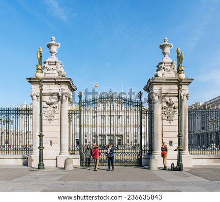 MADRID, NOVEMBER 22: Royal Palace of Madrid, close-up of the west facade (View from the Plaza de la Armeria) with some tourists around on November 22, 2014