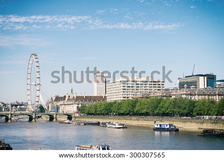 LONDON UK - JULY 10: London Eye and the River Thames with its boats on 10 July 2015
