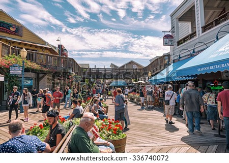 SAN FRANCISCO, CALIFORNIA USA - SEPTEMBER 24: Visitors walk on Pier 39 stores and restaurants on a sunny Summertime day on 24 September 2015