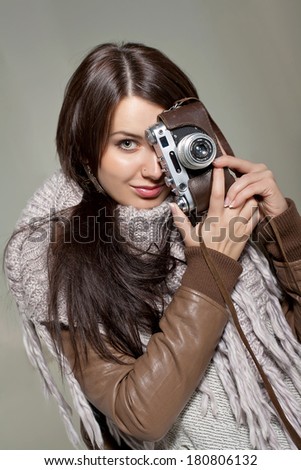 Woman with analog camera against