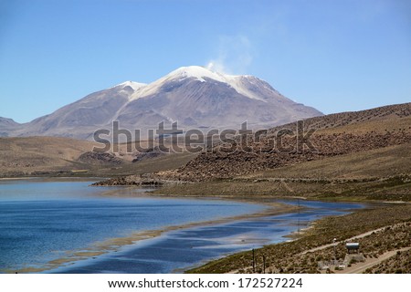 One of the most active volcanoes in Chile.  The active volcano Guallatiri (Wallatiri, Guallatire) lies west of the border with Bolivia and Chile. It is a symmetrical 6071m high ice-clad stratovolcano.