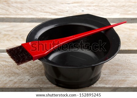 Hair color brush, and bowl on wooden surface