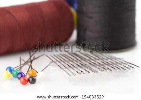Sewing needles, pins and cotton thread