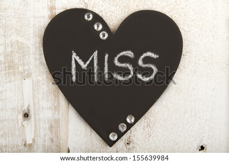 Heart shaped chalk boards with words of inspiration on it on wood background