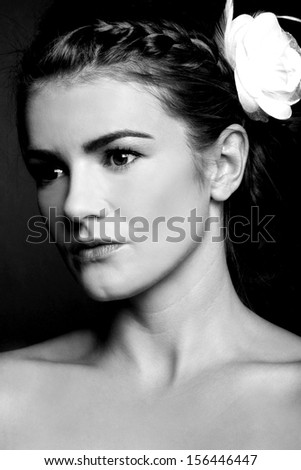 Pretty female with white flower in her hair