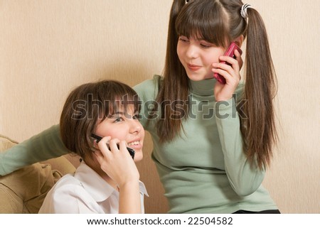 optimistic girls with phones speaks to friends
