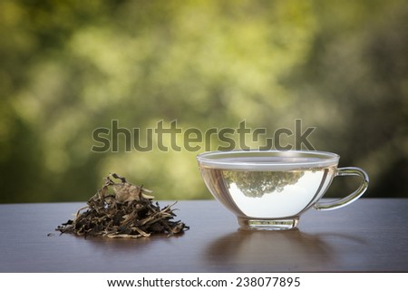 White tea cup and tea leaves