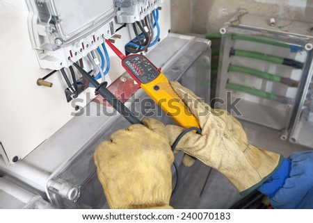 Electrician testing industrial machine