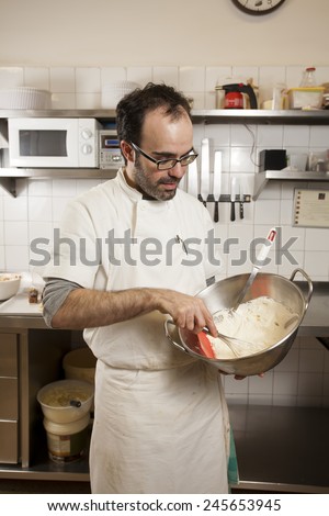 Baker preparing cream in the workshop where he works