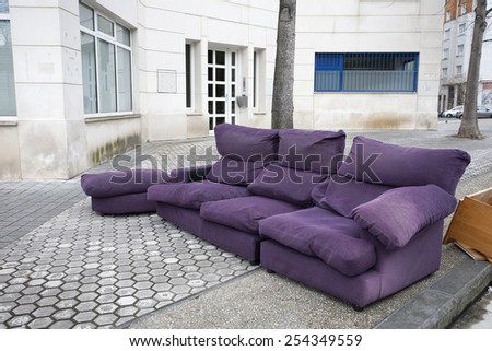 Old purple couch in the street