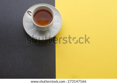 Red tea with black and yellow background