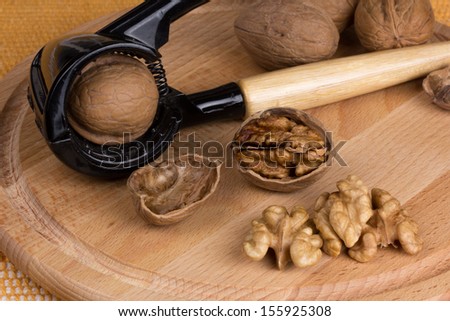 dry walnuts in shell and open to the board