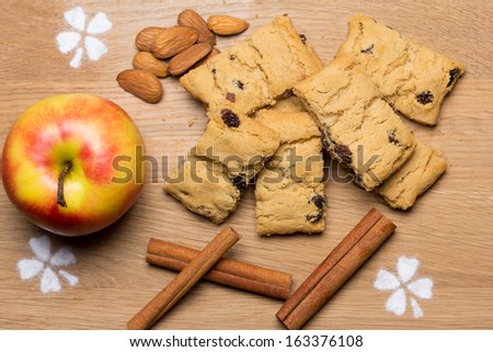 sweet apple cookies with raisins isolated on white background and cinnamon sticks