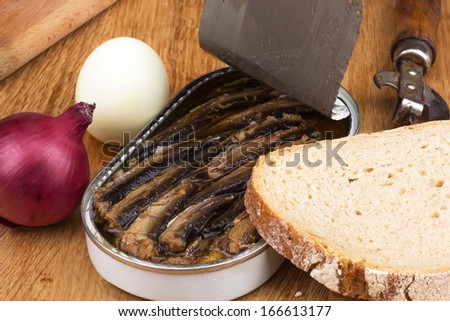 sprats in a tin with red onion, boiled egg, black bread and opener