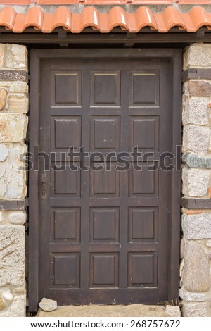 dark door in a stone wall with tiles