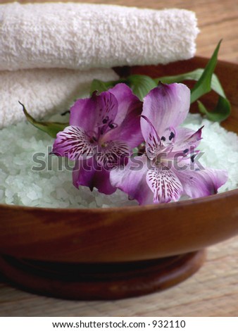 Bath products including folded towels,bath salts and flowers.